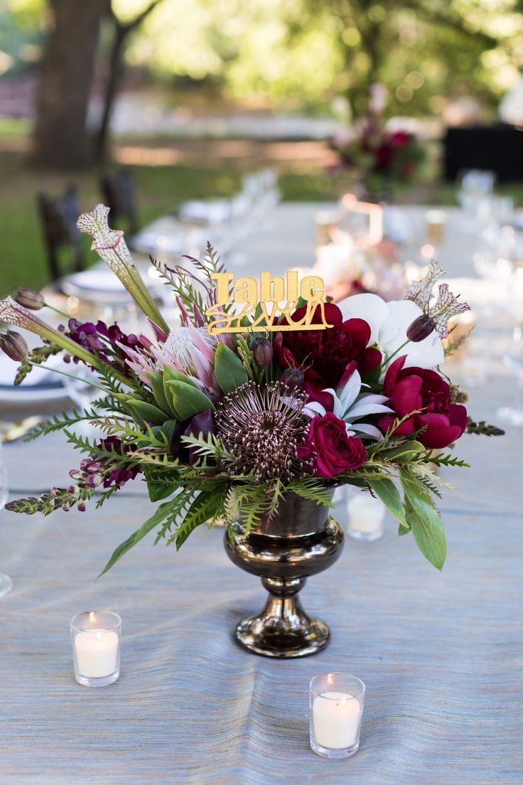 gold table numbers and floral centerpiece