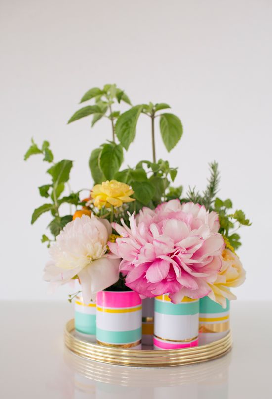This lovely centerpiece is created with multiple small containers, each holding ...